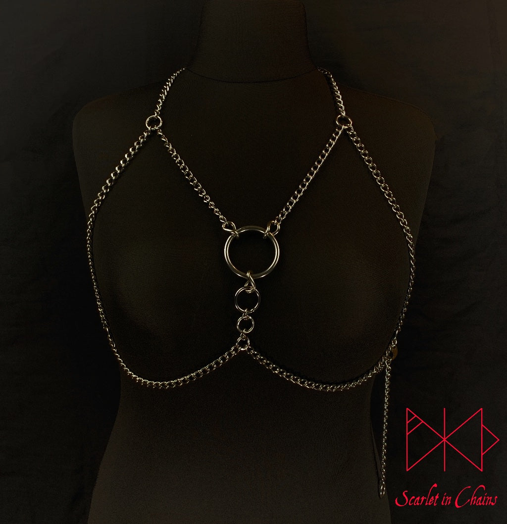 mannequin shot of Alignment body harness worn, a halternect stainless steel chain harness. with triangular chains over the chest bikini top style. with 3 depending in size, Stainless Steel O rings. fasted with a stainless steel clasp at the waistband, goth jewellery alternative jewellery stainless steel jewellery, event jewellery, body chains