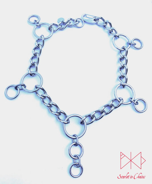 flat image of Coven collar, 3mm stainless steel chain collar with 5 O rings set within the chain to represent the 5 points of the pentagram. hanging from the 4 side rings is 1 smaller O ring hanging off the central O ring is 2 smaller rings with new inks, goth choker alternative collar stainless steel jewellery, goth jewellery, event jewellery. Goth Necklace, Stainless Steel Necklace, Event Necklace