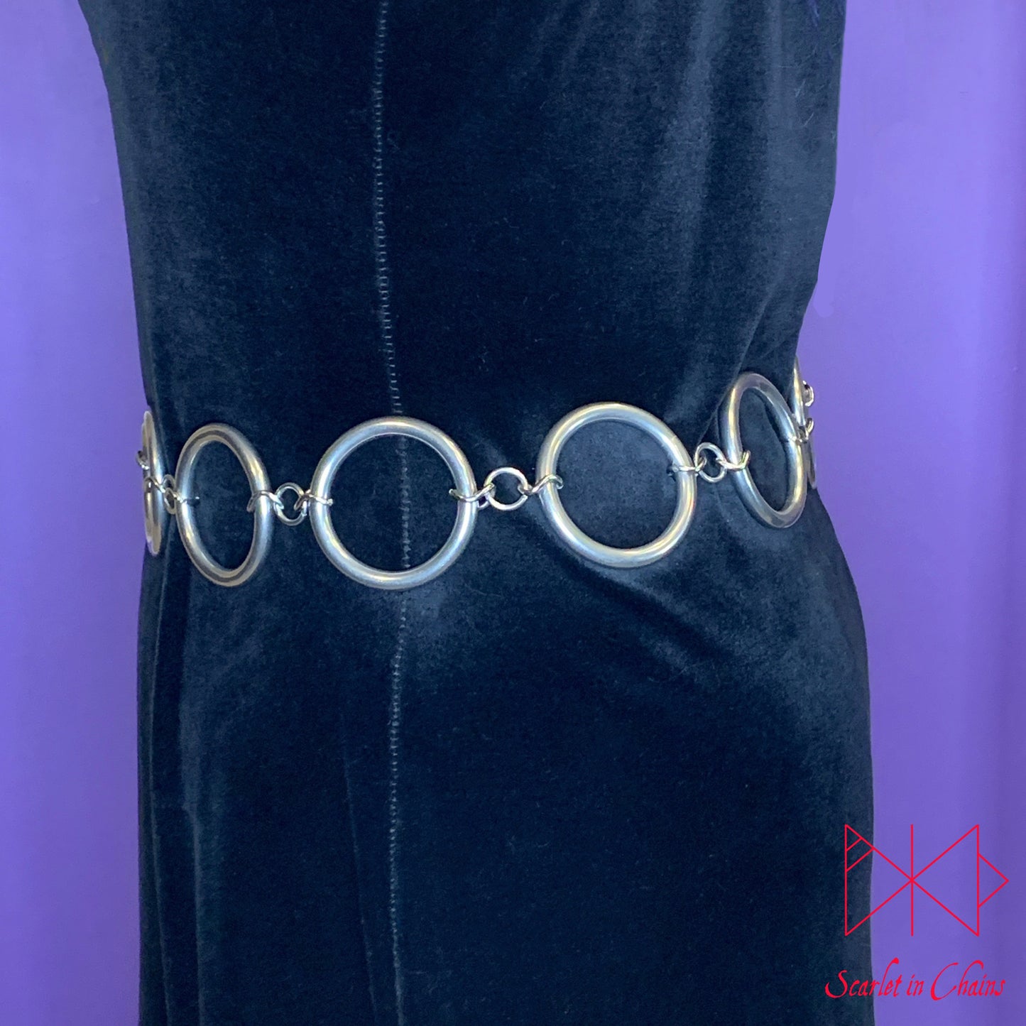 worn shot of Solar belt, large stainless steel O rings joined with large stainless steel chain links Shown side