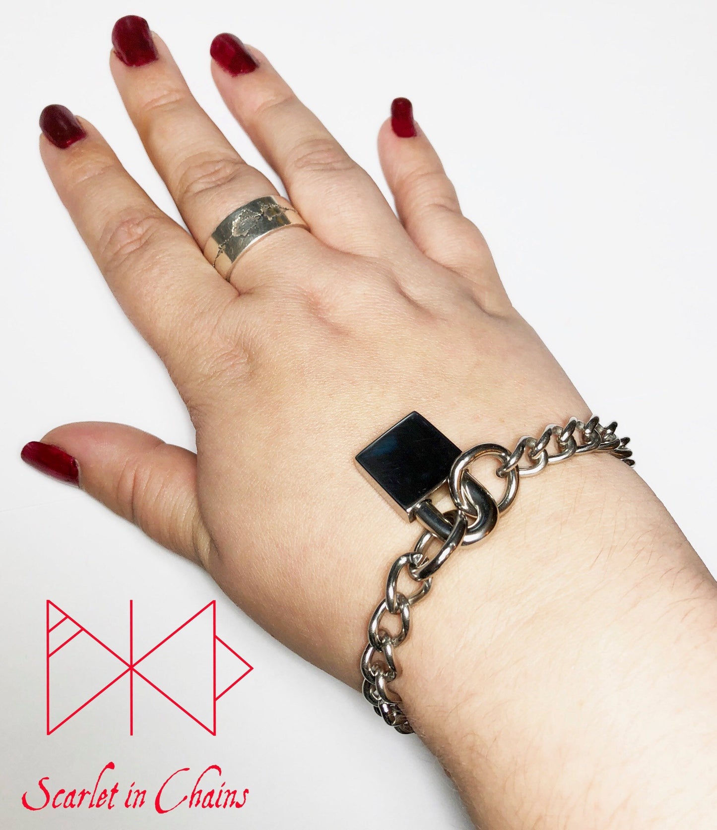 worn shot of stainless steel padlock bracelet