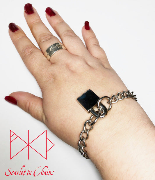 worn shot of stainless steel padlock bracelet