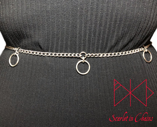 Stainless steel Mystic belt worn shot. The Mystic belt is a mini chain belt with an embedded o ring with a larger O ring hanging from it at each section