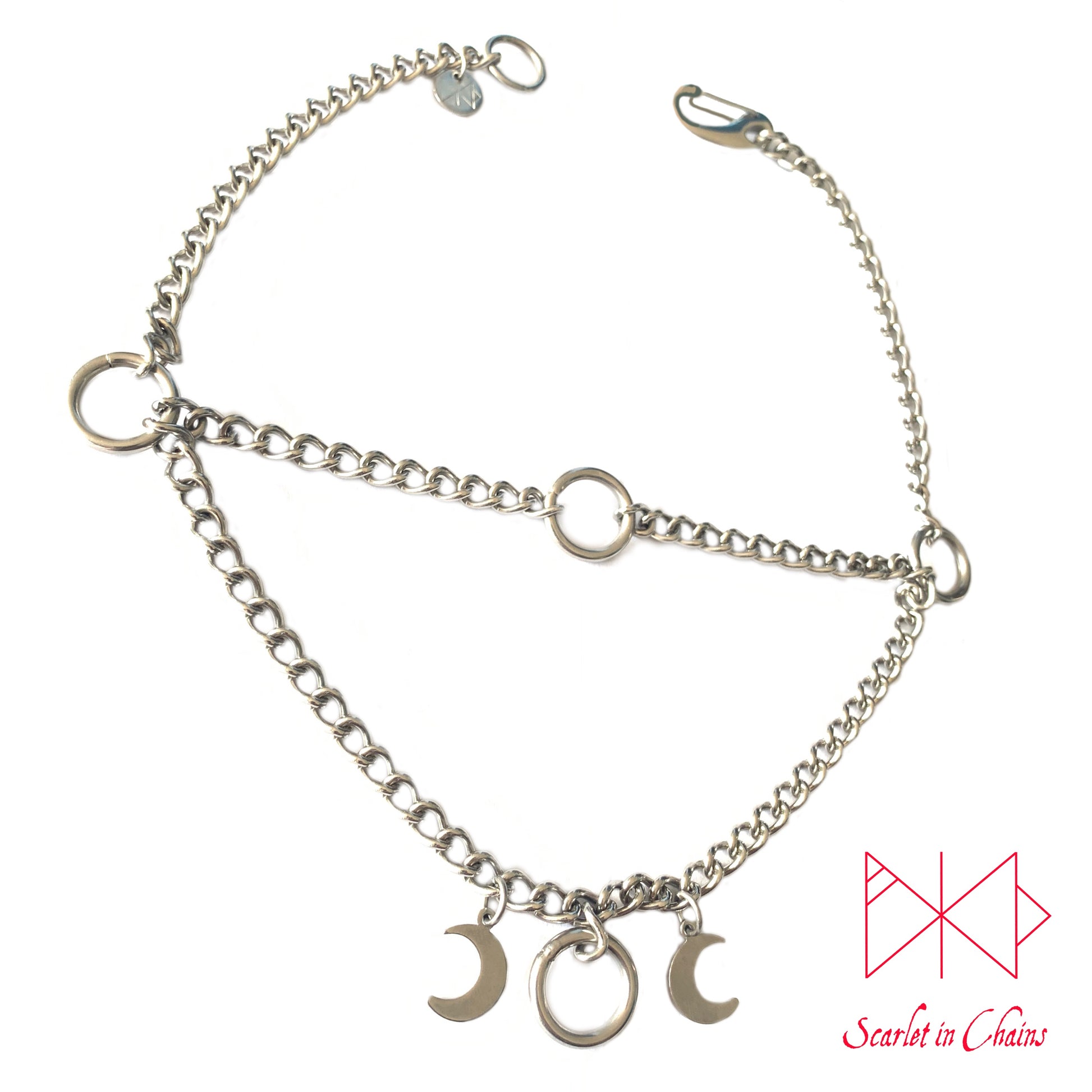 Layered stainless steel chain choker necklace with o ring choker section at the top and the goddess necklace at the base shown with stainless steel clip. flat shot