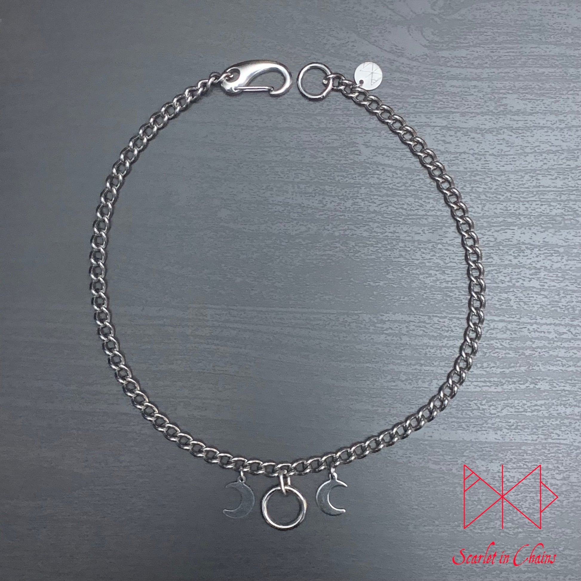 flat shot of micro goddess necklace finished with stainless steel clip