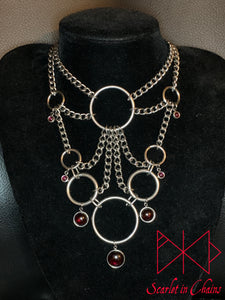 Stainless Steel Roots to Eternity Necklace - Statement Necklace - Garnet - O ring collar showing on stand