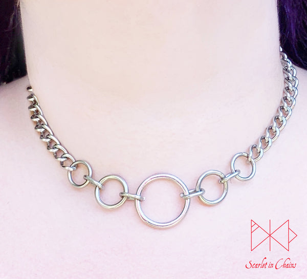 Stainless steel Luna Phase chain choker with multiple o rings in reducing sizes indicating a moon phase pattern. Shown worn with new links