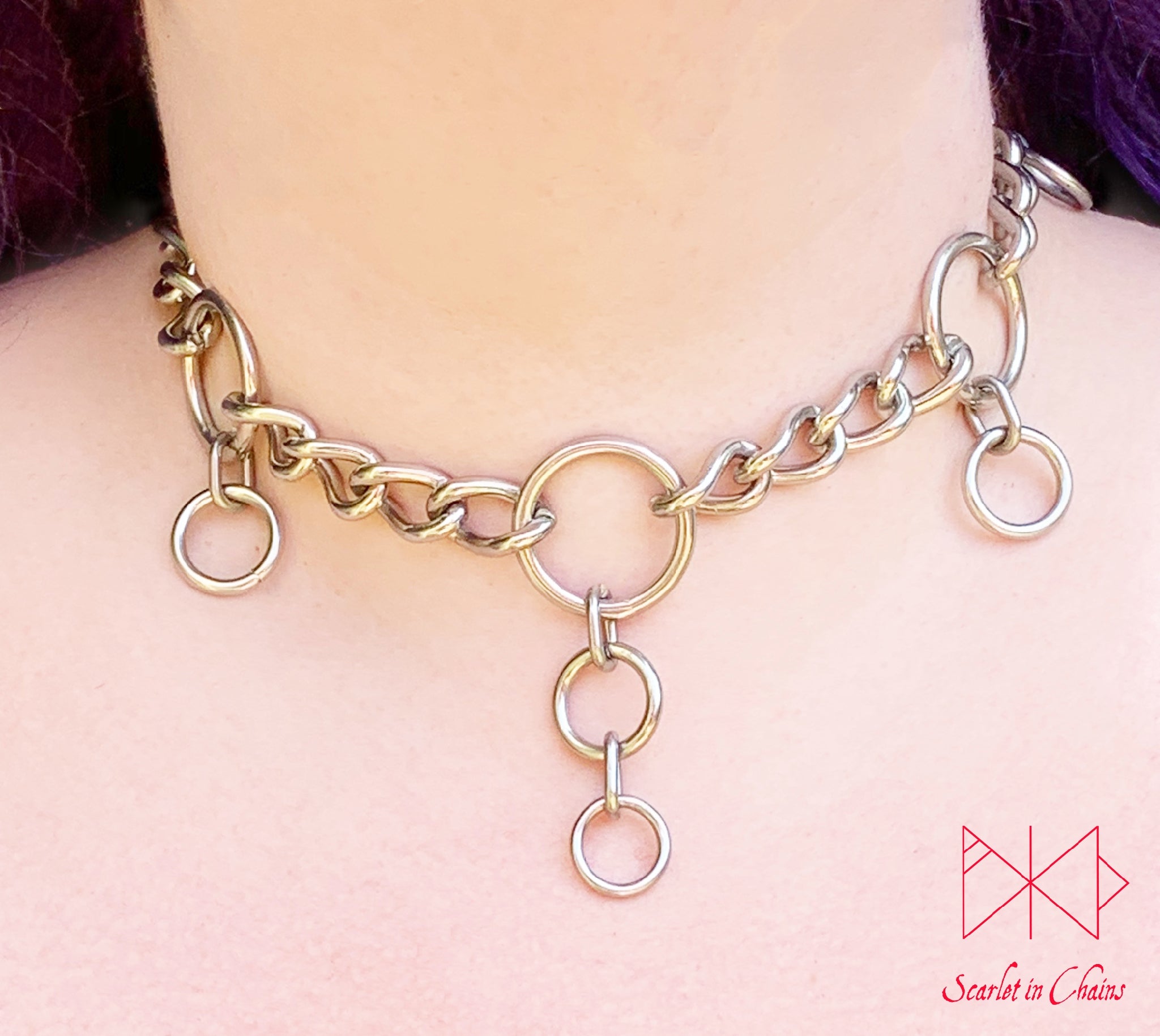Worn image of Coven collar, 3mm stainless steel chain collar with 5 O rings set within the chain to represent the 5 points of the pentagram. hanging from the 4 side rings is 1 smaller O ring hanging off the central O ring is 2 smaller rings with new links