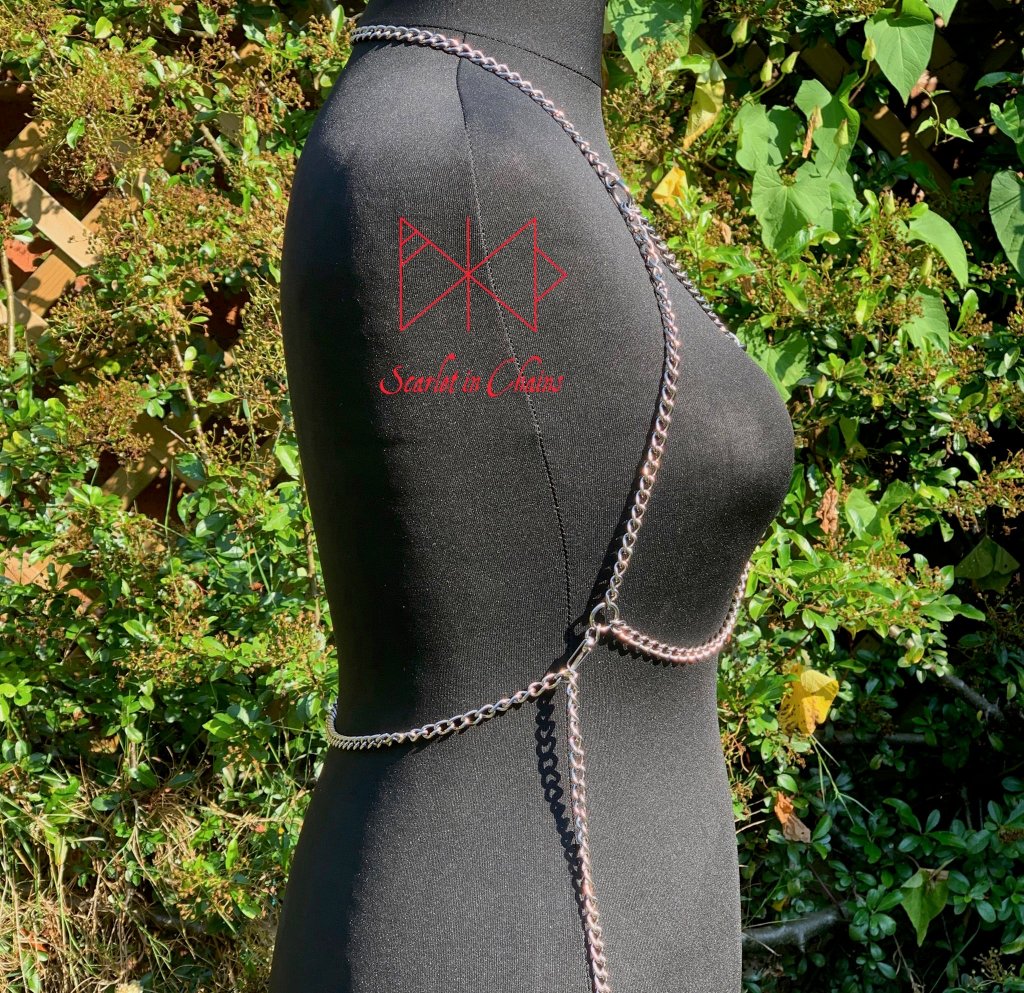 Alignment body harness, a halter-neck stainless steel chain harness. with triangular chains over the chest bikini top style. with 3 depending in size, Stainless Steel O rings. fasted with a stainless steel clasp at the waistband side view