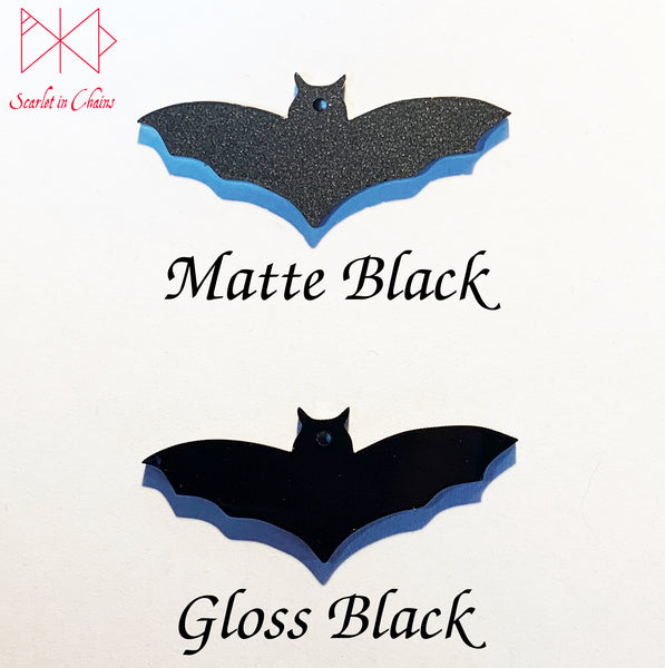 perspex bats showing the difference between matte black and gloss black