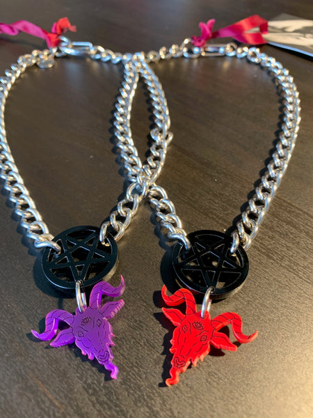Flat shots of red and purple baphomet chokers