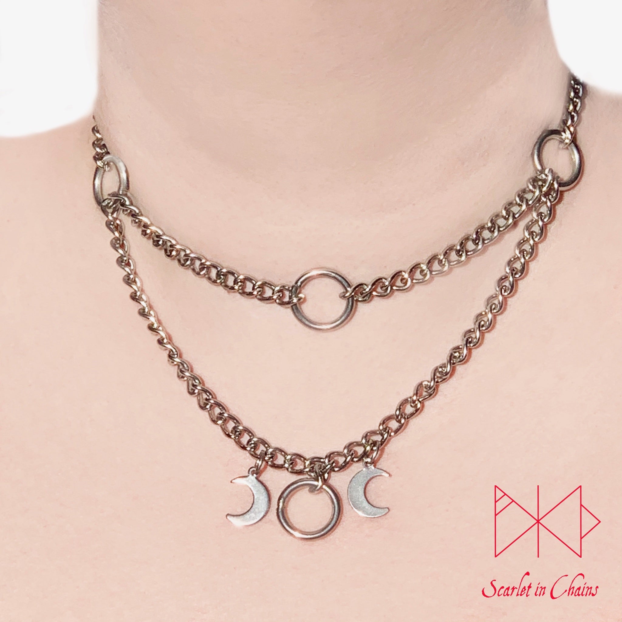 Layered stainless steel chain choker necklace with o ring choker section at the top and the goddess necklace at the base. worn
