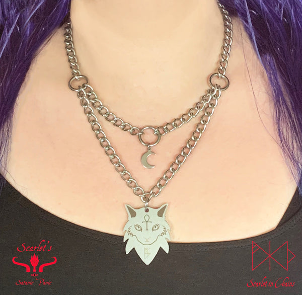 far shot of stainless steel double layer necklace featuring a stainless steel mini crescent  on the top layer and a limited edition Sabra the cat charm on the bottom layer 