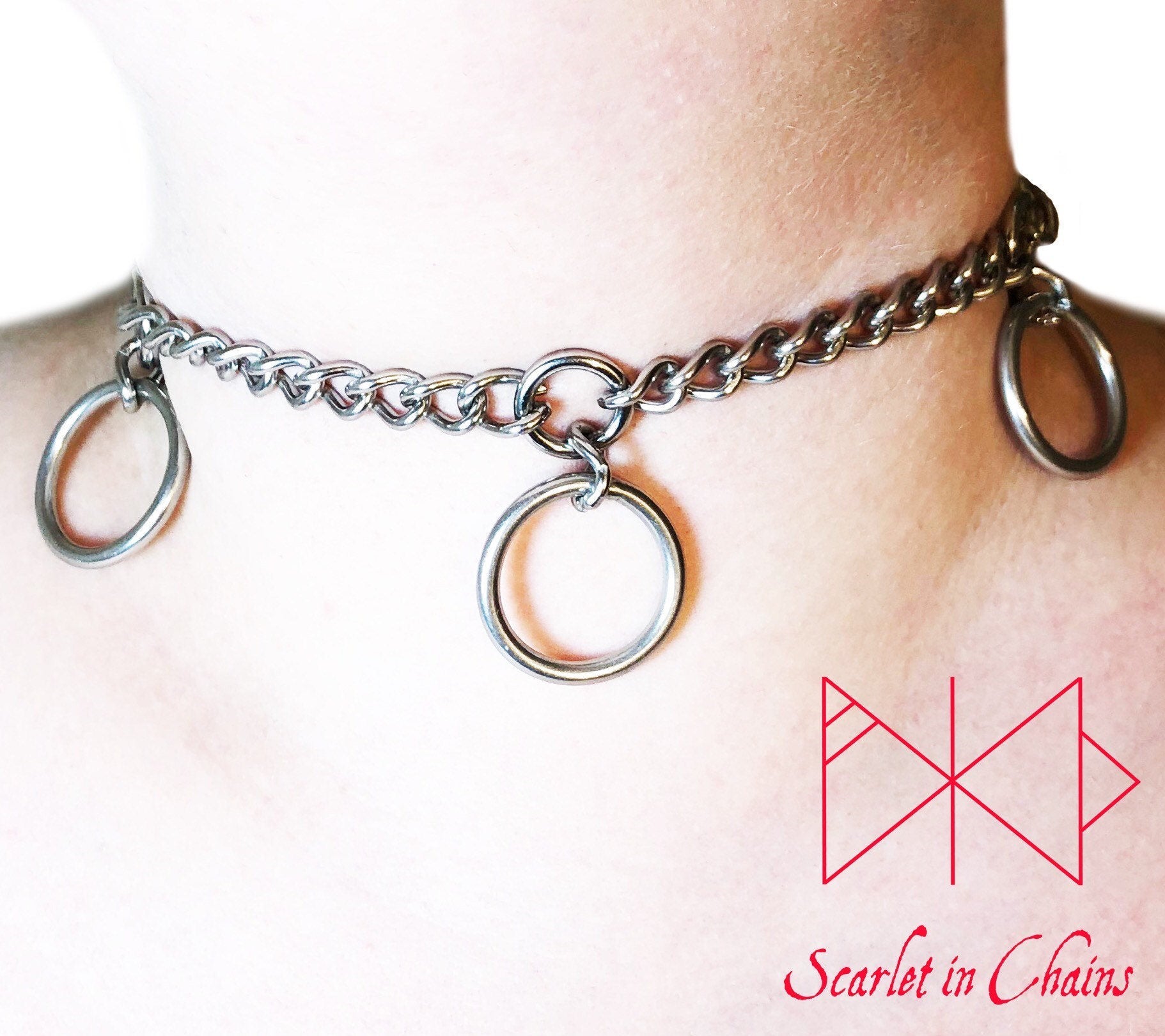 Worn shot of Mystic choker, stainless steel chain choker with small inset O rings with a large o ring suspended from each one