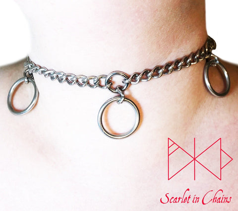 Worn shot of Mystic choker, stainless steel chain choker with small inset O rings with a large o ring suspended from each one