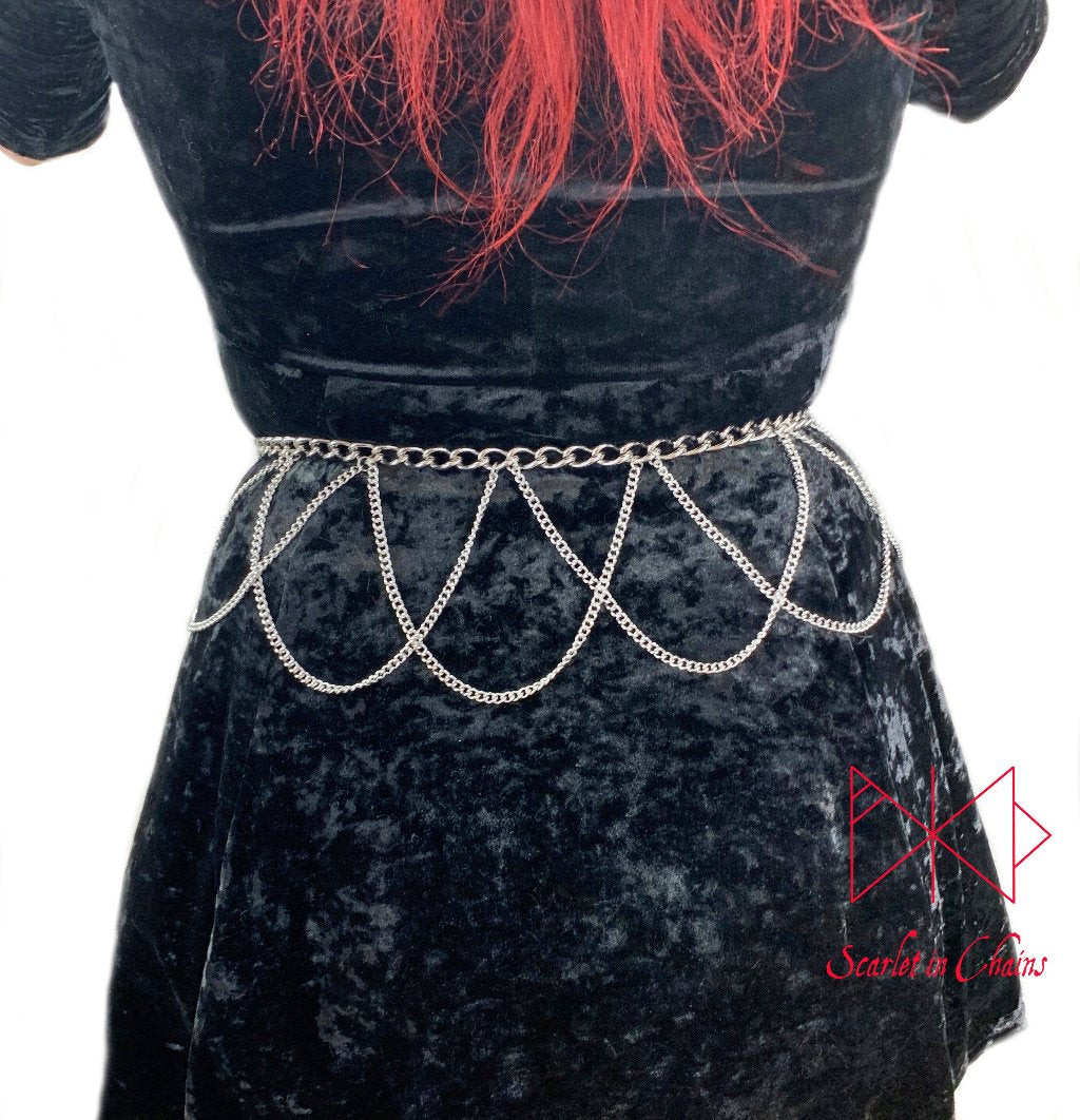 Countess belt worn, Stainless steel chain belt with thinner stainless steel chain loops hanging from it in a lace style pattern